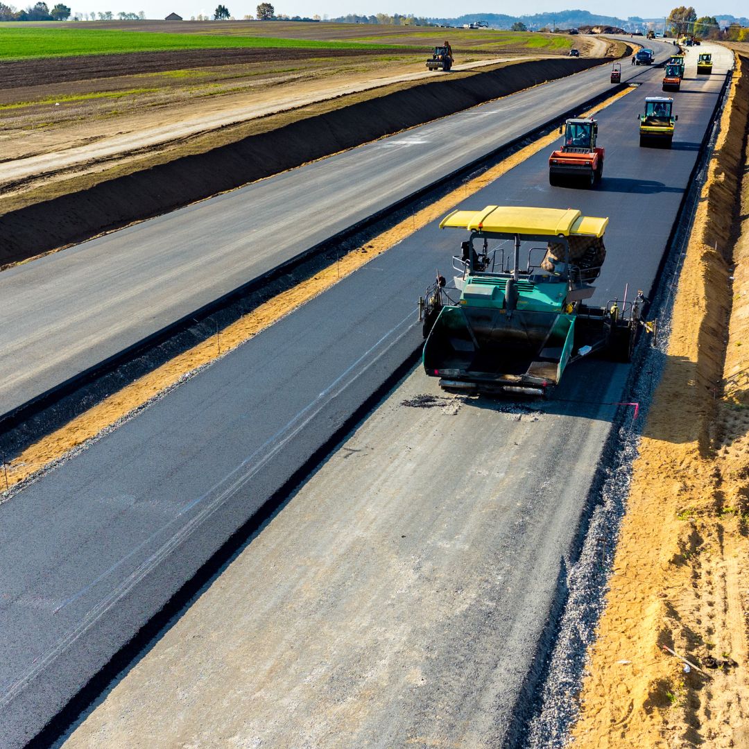 more than 10 rollers drive down asphalt on construction jobsite