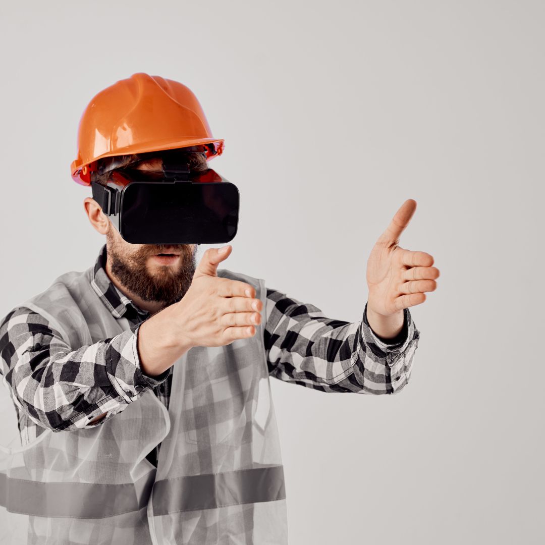 man wearing flannel shirt in construction hat and VR glasses